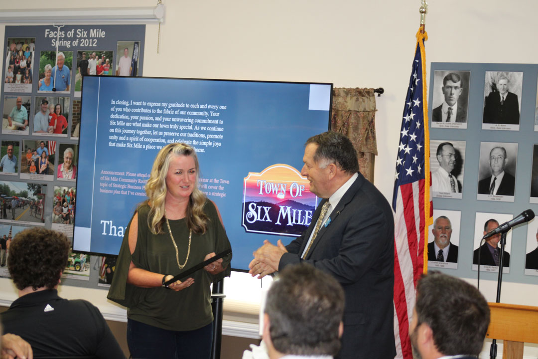 Jenni Brink, owner of Red, White, and Brew Coffee Company in Six Mile, is presented the Business of the Year Award from Mayor James Atkinson (Photo by Karen Brewer, The Pickens County Chronicle)