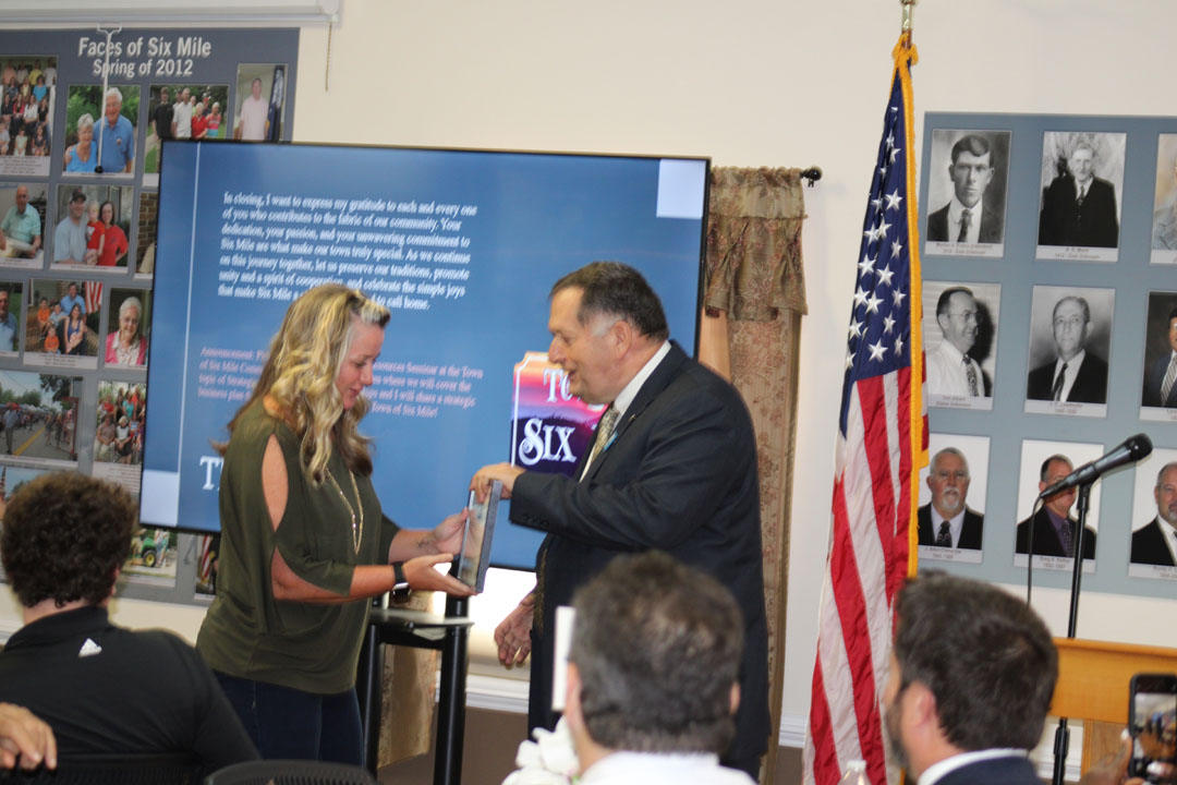 Six Mile Mayor James Atkinson presents Jenni Brink the Business of the Year Award for Red, White, and Brew Coffee Company (Photo by Karen Brewer, The Pickens County Chronicle)