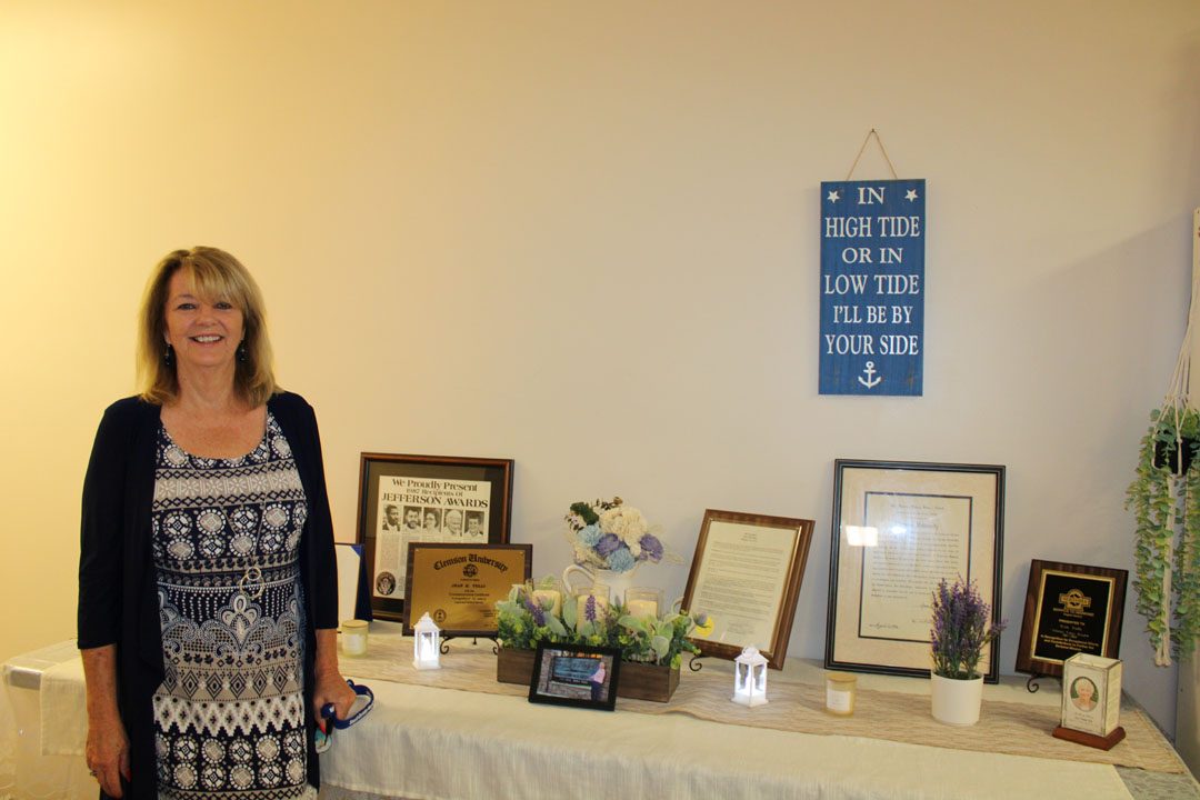 Helping Hands Executive Director Brigitte Stephens at a table dedicated to the memory of founder and former Executive DirectorJean Tulli (Photo by Karen Brewer, The Pickens County Chronicle)