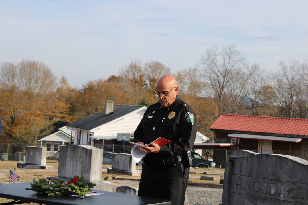 Pickens Poilce Chief Randall Beach, Chaplain, Third Battalion Fourth MarinesAsst, reads scripture  and speaks at the Wreaths Across America ceremony. (Photo by Karen Brewer, The Pickens County Chronicle)