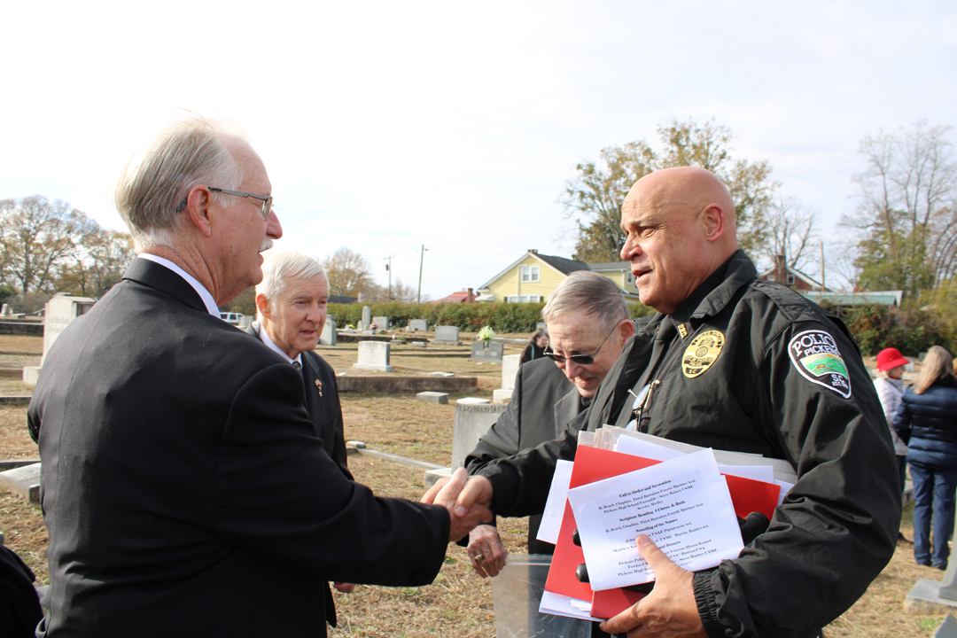 Chief Beach shakes hands with a member of the Knights of Columbus. (Photo by Karen Brewer, The Pickens County Chronicle)