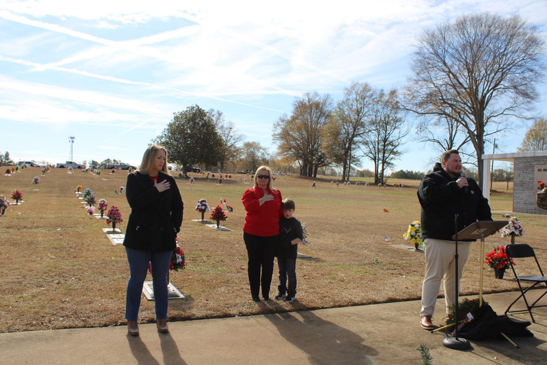 Melanie Gillespie, Amy Barrett, and Easton Barrett as Zachary Ryder sings the national anthem (Photo by Karen Brewer, The Pickens County Chronicle)