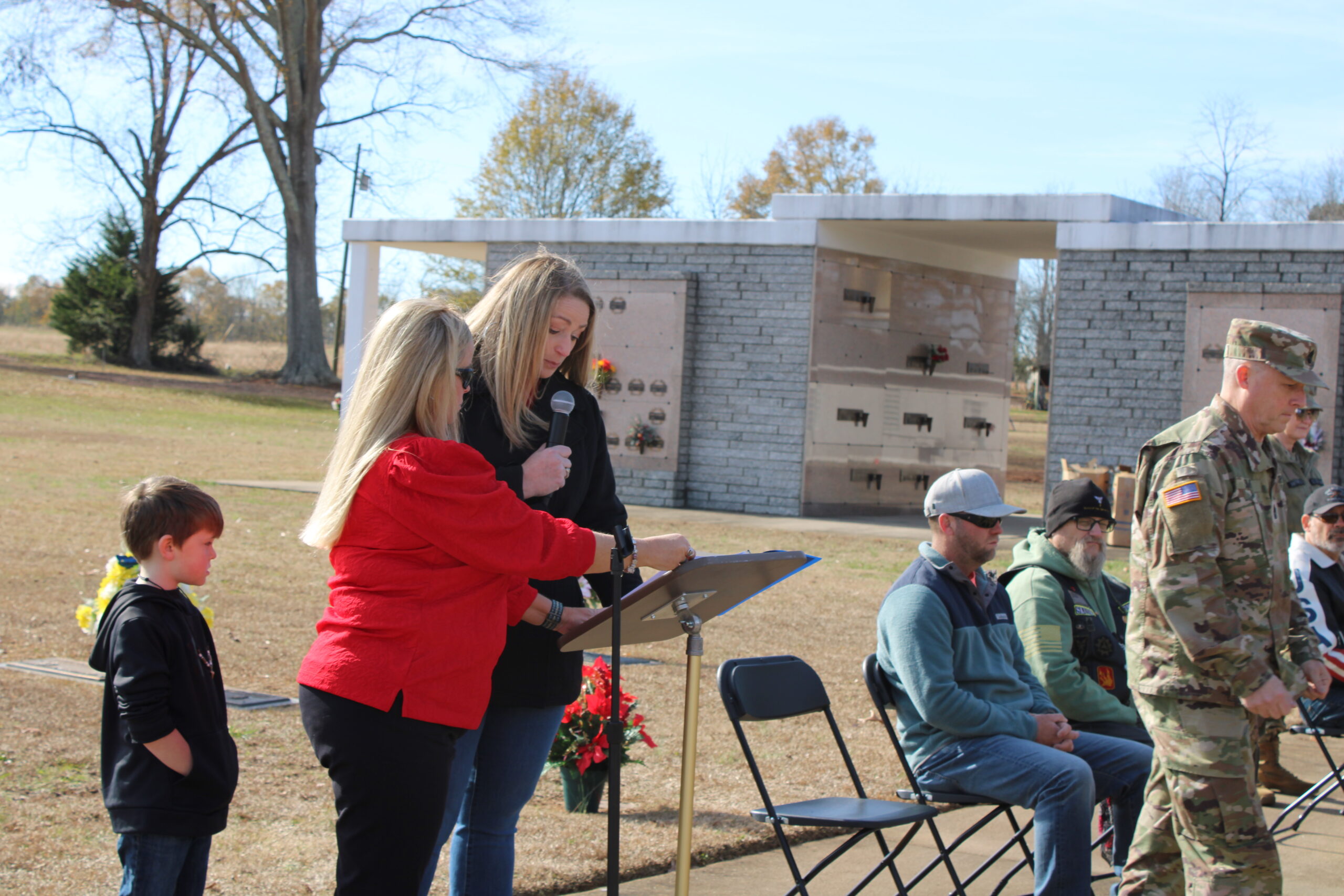 Melanie Gillespie introduces the ceremonial wreath presenters, who are assisted by Jessica Varneyy, SC State Guard.. (Photo by Karen Brewer, The Pickens County Chronicle)