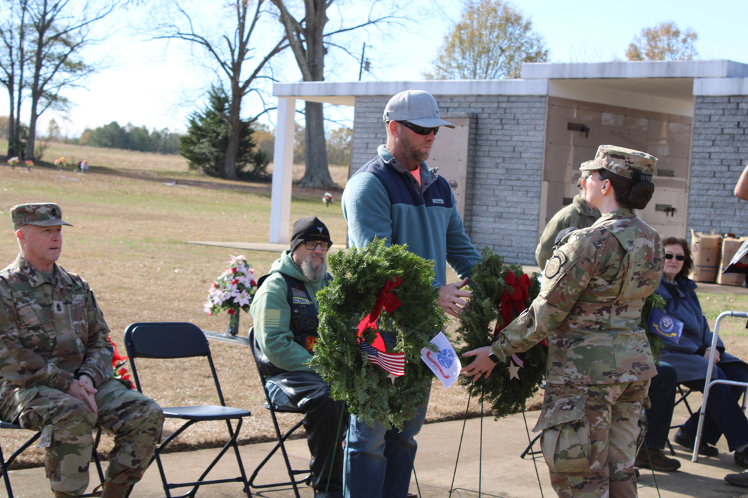 Daniel McGown, US Marines, places a wreath in memory of those who served in the US Marine Corps (Photo by Karen Brewer, The Pickens County Chronicle)