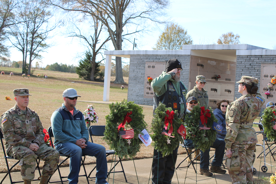 Eric Higham, US Army, salutes after placing a wreath in memory of those who served in the US Navy (Photo by Karen Brewer, The Pickens County Chronicle)