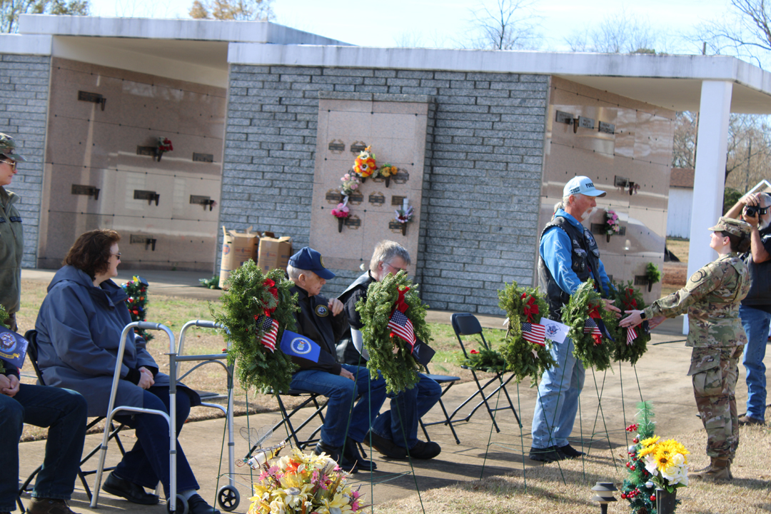 Mike Eurell, US Navy, places a wreath in memory of the members of all branches of service whose last known status was prisoner of war or missing in action. (Photo by Karen Brewer, The Pickens County Chronicle)