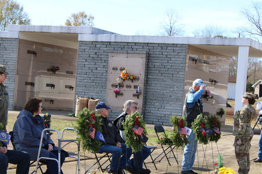 Mike Eurell, US Navy, salutes after placing a wreath in memory of the members of all branches of service whose last known status was prisoner of war or missing in action. (Photo by Karen Brewer, The Pickens County Chronicle)