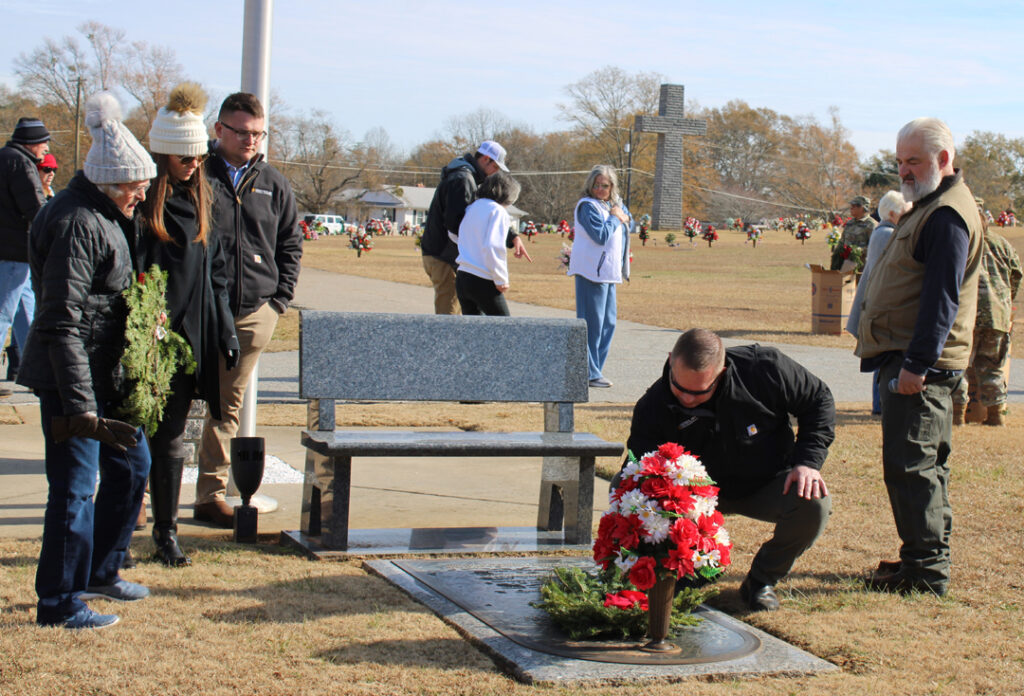 Brad Holtzclaw, President of Liberty Mortuary, places a wreath. (Photo by Karen Brewer, The Pickens County Chronicle)