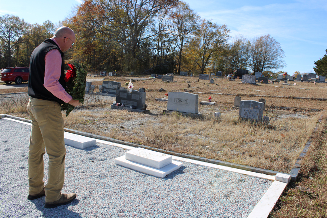 Reid Bagwell, of Liberty Mortuary, places a wreath at the gravesite of William McWhorter, one of Pickens County's four Medal of Honor recipients, buried at adjacent Westview Cemetery. (Photo by Karen Brewer, The Pickens County Chronicle)