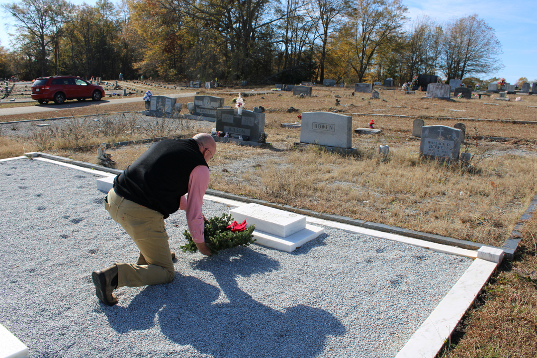 Reid Bagwell places a wreath upon the grave of William McWhorter, one of Pickens County's four Medal of Honor recipients (Photo by Karen Brewer, The Pickens County Chronicle)