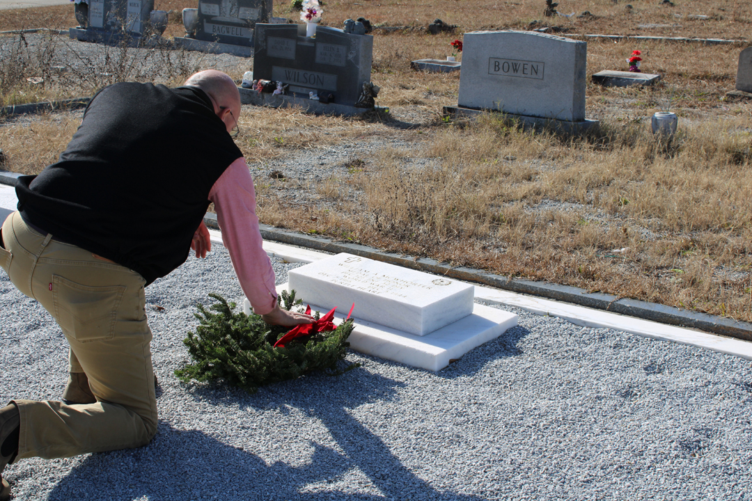 Reid Bagwell places a wreath at the gravesite of William McWhorter, one of Pickens County's Medal of Honor recipients.