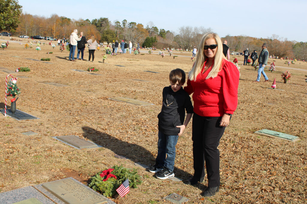 Amy Barrett with grandson Easton Barrett after placing a wreath. (Photo by Karen Brewer, The Pickens County Chronicle)