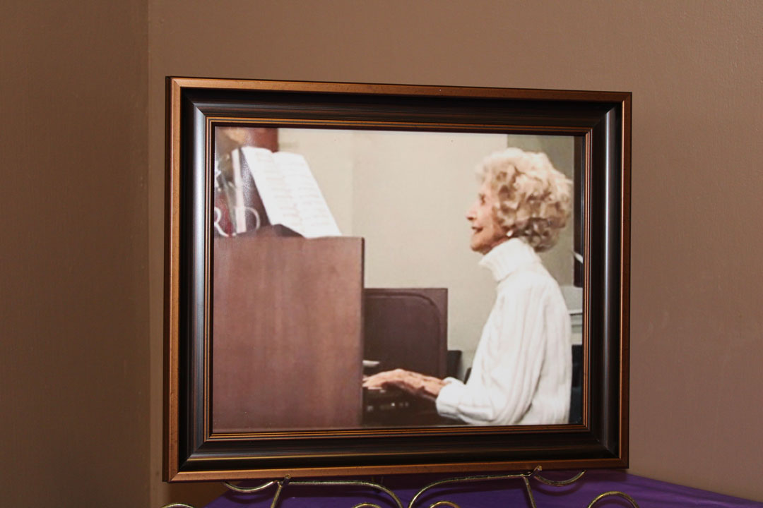 A photograph of Martha Childress playing the organ