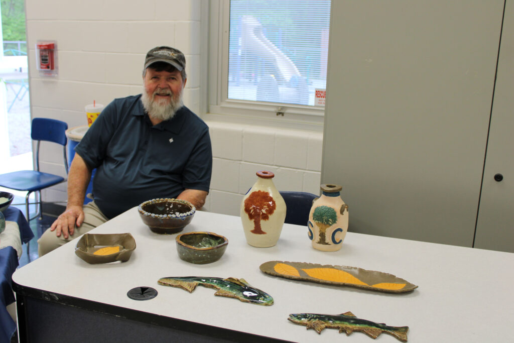 Jim Garrison with pottery he made at The Holly Springs Center (Photo by Karen Brewer, The Pickens County Chronicle)