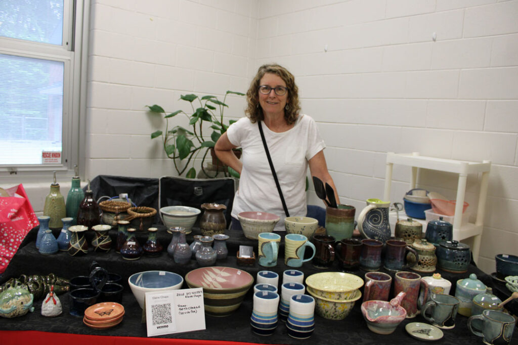 Elaine Chapa with her pottery (Photo by Karen Brewer, The Pickens County Chronicle)