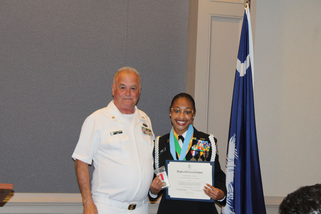 Student Kaleaha Cook  (right) with her JROTC instructor, Mark Stauder (Photo by Karen Brewer, The Pickens County Chronicle)