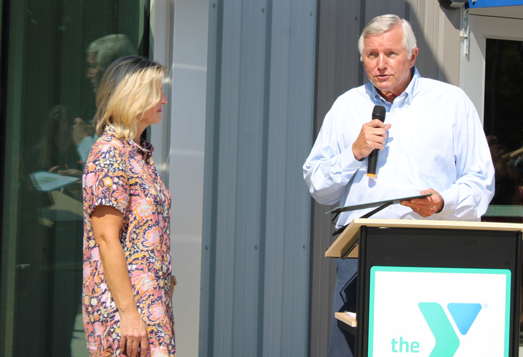 Rick Cothran, Director of Membership and Engagement with the Easley Chamber of Commerce, presents Kim Valentin with a gift of $1 from the Easley Chamber of Commerce. (Photo by Karen Brewer, The Pickens County Chronicle)