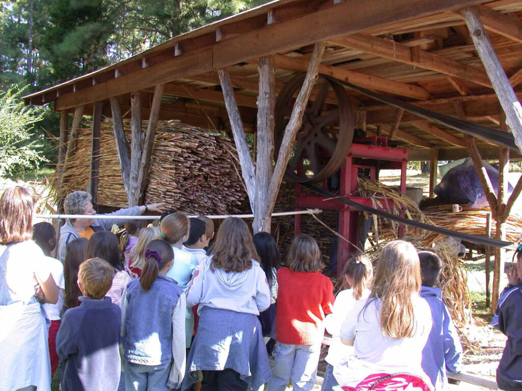 ANNE SHERIFF AT COLLINS OLE TOWN-DEMONSTRATING TO CHILDREN