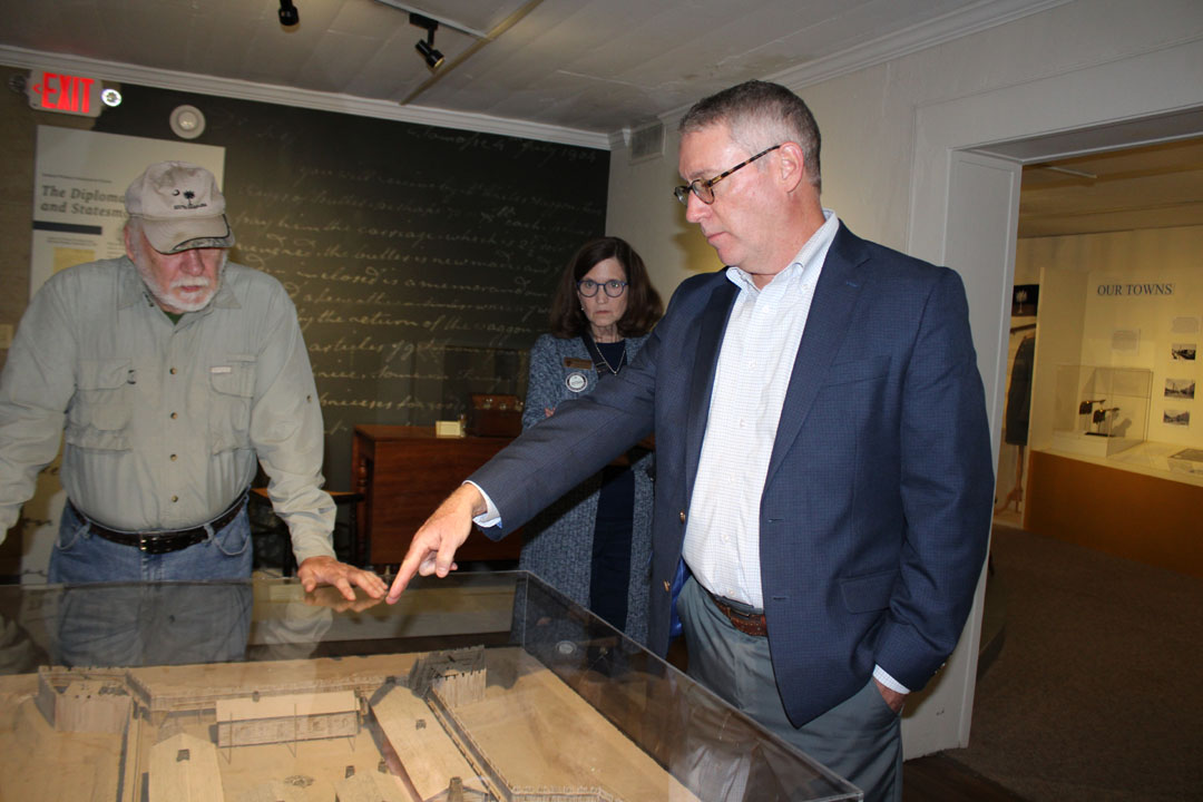 Pickens County Administrator Ken Roper speaks about Fort Prince George during the grand opening of the Andrew Pickens Exhibit at the Pickens County Museum of Art & History. Also pictured are Dennis Chastain (Blue Wall Vice President for the Pickens County Historical Society) and his wife, Jane Chastain (Membership Director of the Pickens County Historical Society). (Photo by Karen Brewer, The Pickens County Chronicle)