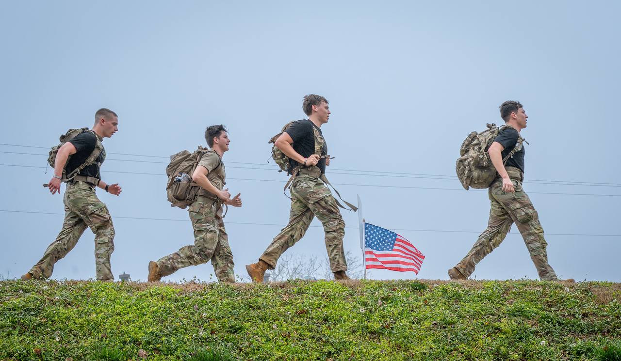 Hundreds of people participate in the 2026 Clemson 8 Challenge, an eight-mile run/walk/ruck march, on a misty Saturday morning, March 7, 2026. The Challenge was created to honor the 25 known Clemson alumni who suffered as POWs in all wars. It was originally created for 1938 Clemson alumnus, professor emeritus and WWII hero Ben Skardon, a survivor of the Bataan Death March, but has expanded to include Clemson POWs from all wars. Money raised from the event goes toward sending teams of Clemson ROTC students to participate in the Bataan Memorial Death March at White Sands Missile Range, NM. Sophomore finance major GB Stalnaker served as master of ceremonies. (Photo by Ken Scar)
