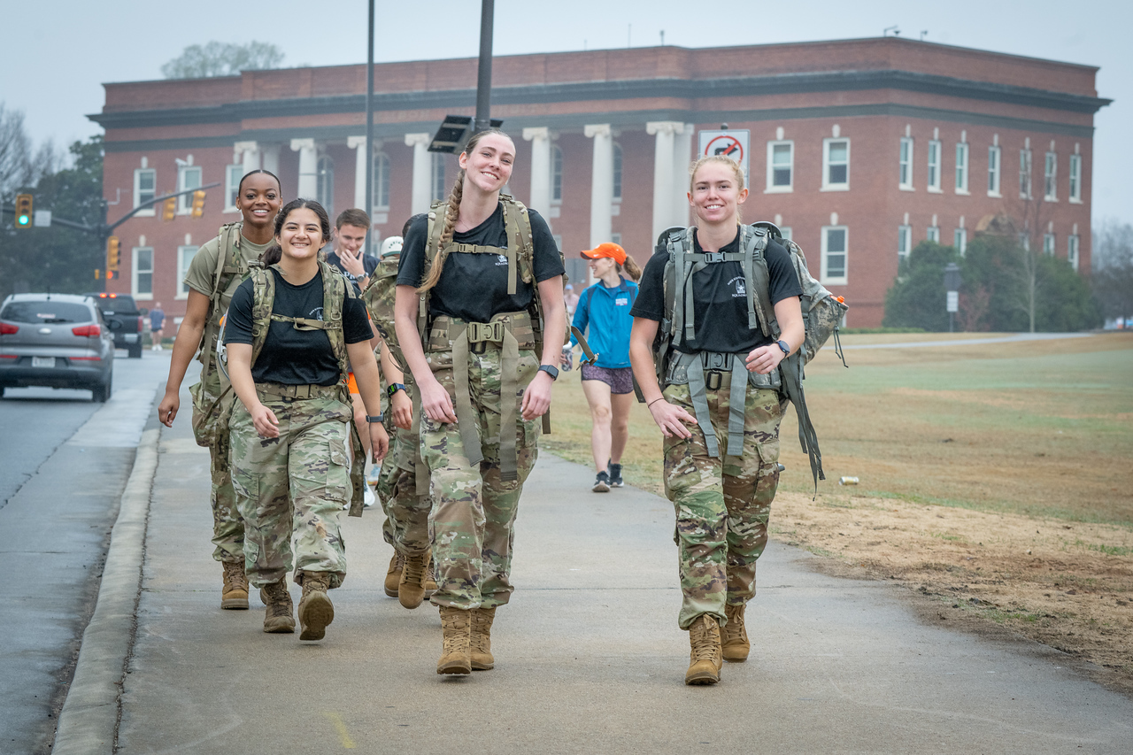 Hundreds of people participate in the 2026 Clemson 8 Challenge, an eight-mile run/walk/ruck march, on a misty Saturday morning, March 7, 2026. The Challenge was created to honor the 25 known Clemson alumni who suffered as POWs in all wars. It was originally created for 1938 Clemson alumnus, professor emeritus and WWII hero Ben Skardon, a survivor of the Bataan Death March, but has expanded to include Clemson POWs from all wars. Money raised from the event goes toward sending teams of Clemson ROTC students to participate in the Bataan Memorial Death March at White Sands Missile Range, NM. Sophomore finance major GB Stalnaker served as master of ceremonies. (Photo by Ken Scar)