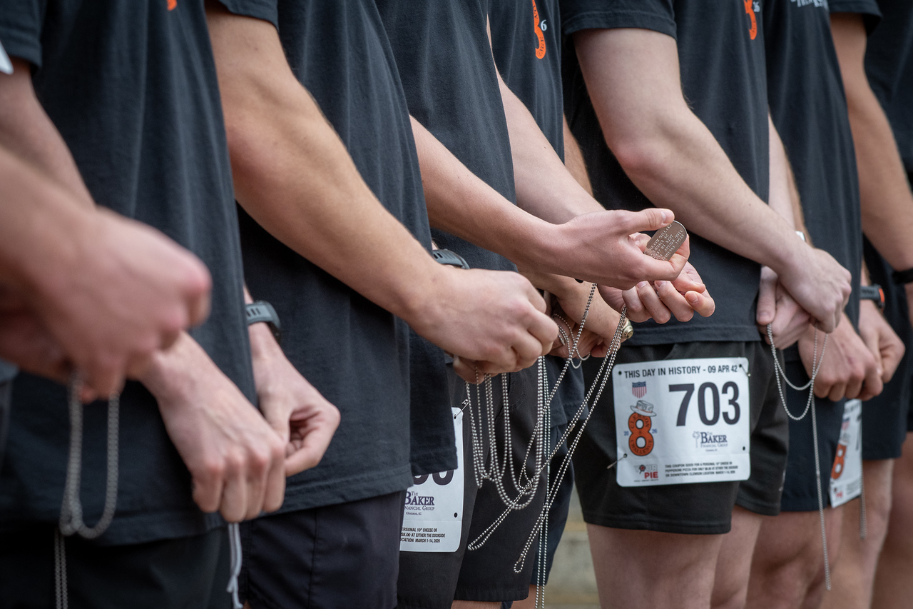 Hundreds of people participate in the 2026 Clemson 8 Challenge, an eight-mile run/walk/ruck march, on a misty Saturday morning, March 7, 2026. The Challenge was created to honor the 25 known Clemson alumni who suffered as POWs in all wars. It was originally created for 1938 Clemson alumnus, professor emeritus and WWII hero Ben Skardon, a survivor of the Bataan Death March, but has expanded to include Clemson POWs from all wars. Money raised from the event goes toward sending teams of Clemson ROTC students to participate in the Bataan Memorial Death March at White Sands Missile Range, NM. Sophomore finance major GB Stalnaker served as master of ceremonies. (Photo by Ken Scar)