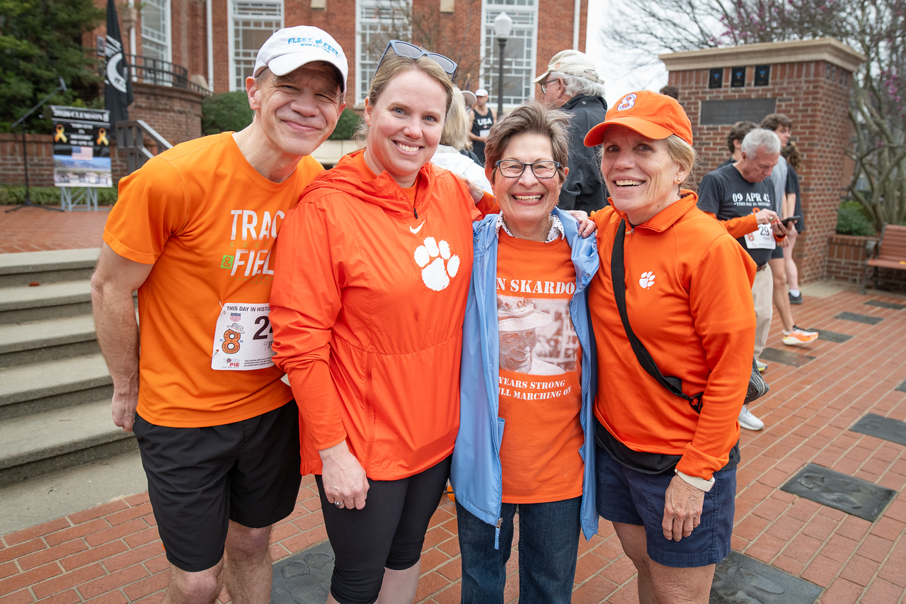 Hundreds of people participate in the 2026 Clemson 8 Challenge, an eight-mile run/walk/ruck march, on a misty Saturday morning, March 7, 2026. The Challenge was created to honor the 25 known Clemson alumni who suffered as POWs in all wars. It was originally created for 1938 Clemson alumnus, professor emeritus and WWII hero Ben Skardon, a survivor of the Bataan Death March, but has expanded to include Clemson POWs from all wars. Money raised from the event goes toward sending teams of Clemson ROTC students to participate in the Bataan Memorial Death March at White Sands Missile Range, NM. Sophomore finance major GB Stalnaker served as master of ceremonies. (Photo by Ken Scar)