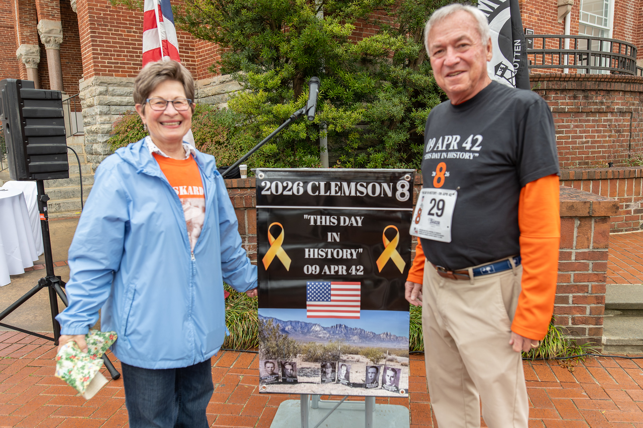 Hundreds of people participate in the 2026 Clemson 8 Challenge, an eight-mile run/walk/ruck march, on a misty Saturday morning, March 7, 2026. The Challenge was created to honor the 25 known Clemson alumni who suffered as POWs in all wars. It was originally created for 1938 Clemson alumnus, professor emeritus and WWII hero Ben Skardon, a survivor of the Bataan Death March, but has expanded to include Clemson POWs from all wars. Money raised from the event goes toward sending teams of Clemson ROTC students to participate in the Bataan Memorial Death March at White Sands Missile Range, NM. Sophomore finance major GB Stalnaker served as master of ceremonies. (Photo by Ken Scar)