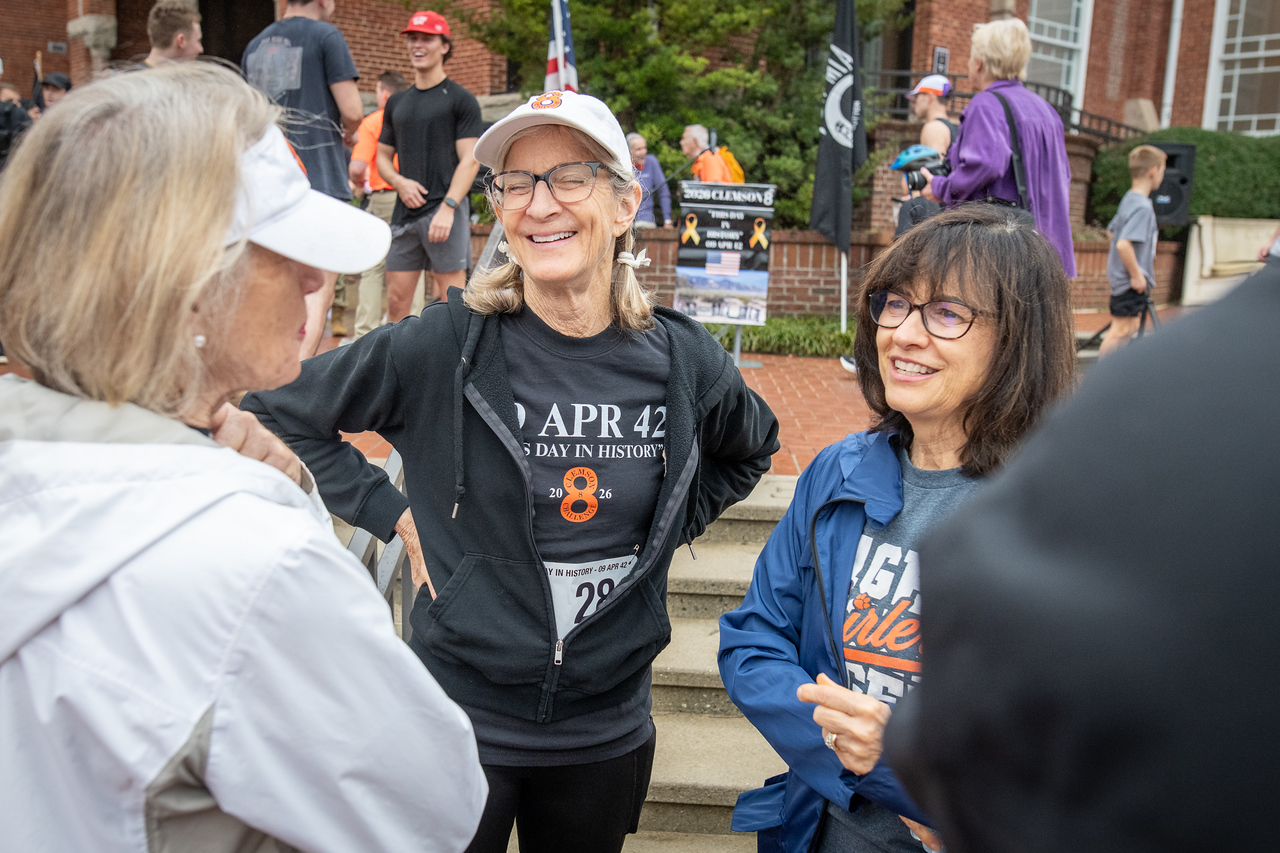 Hundreds of people participate in the 2026 Clemson 8 Challenge, an eight-mile run/walk/ruck march, on a misty Saturday morning, March 7, 2026. The Challenge was created to honor the 25 known Clemson alumni who suffered as POWs in all wars. It was originally created for 1938 Clemson alumnus, professor emeritus and WWII hero Ben Skardon, a survivor of the Bataan Death March, but has expanded to include Clemson POWs from all wars. Money raised from the event goes toward sending teams of Clemson ROTC students to participate in the Bataan Memorial Death March at White Sands Missile Range, NM. Sophomore finance major GB Stalnaker served as master of ceremonies. (Photo by Ken Scar)