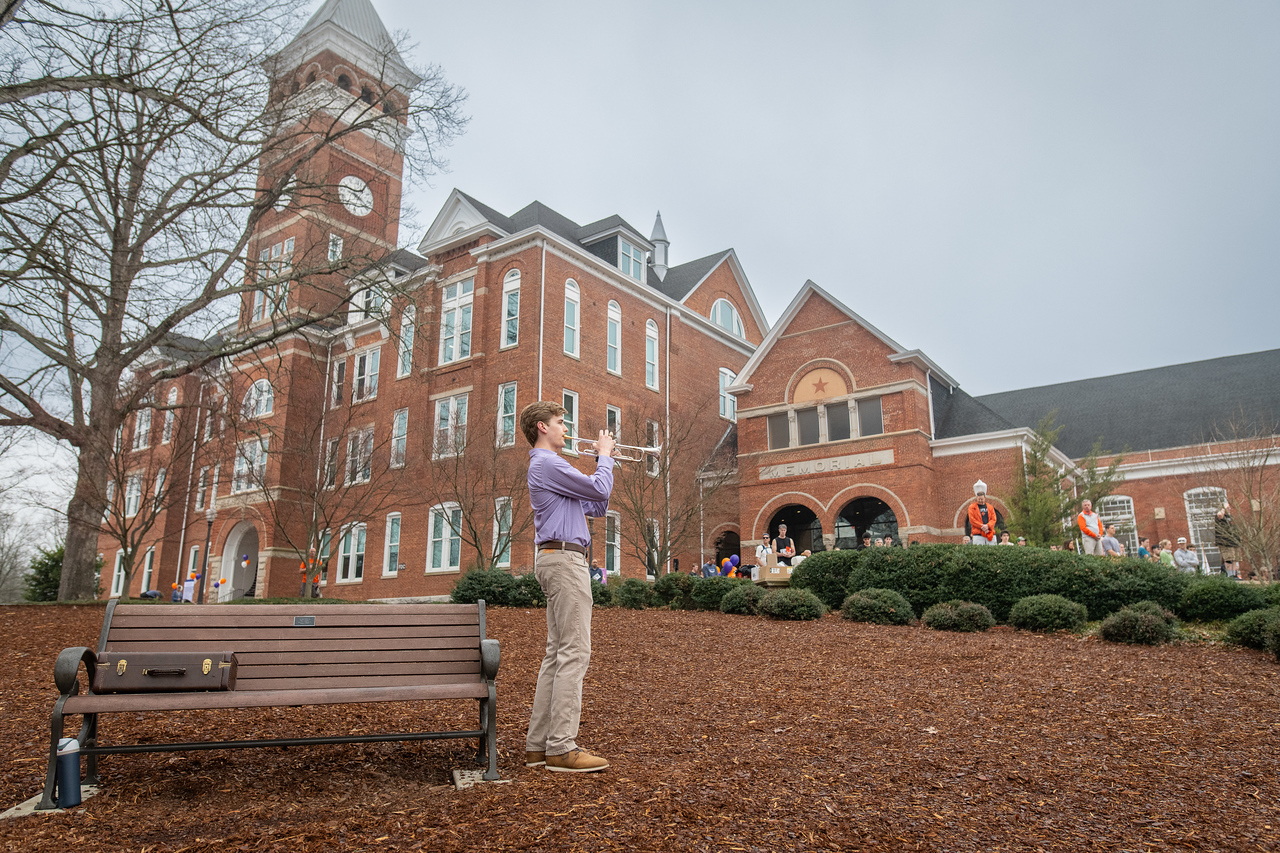 Hundreds of people participate in the 2026 Clemson 8 Challenge, an eight-mile run/walk/ruck march, on a misty Saturday morning, March 7, 2026. The Challenge was created to honor the 25 known Clemson alumni who suffered as POWs in all wars. It was originally created for 1938 Clemson alumnus, professor emeritus and WWII hero Ben Skardon, a survivor of the Bataan Death March, but has expanded to include Clemson POWs from all wars. Money raised from the event goes toward sending teams of Clemson ROTC students to participate in the Bataan Memorial Death March at White Sands Missile Range, NM. Sophomore finance major GB Stalnaker served as master of ceremonies. (Photo by Ken Scar)