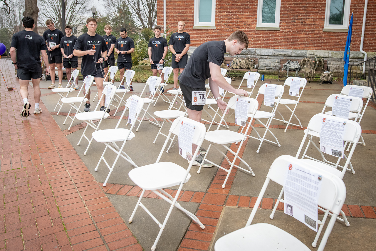 Hundreds of people participate in the 2026 Clemson 8 Challenge, an eight-mile run/walk/ruck march, on a misty Saturday morning, March 7, 2026. The Challenge was created to honor the 25 known Clemson alumni who suffered as POWs in all wars. It was originally created for 1938 Clemson alumnus, professor emeritus and WWII hero Ben Skardon, a survivor of the Bataan Death March, but has expanded to include Clemson POWs from all wars. Money raised from the event goes toward sending teams of Clemson ROTC students to participate in the Bataan Memorial Death March at White Sands Missile Range, NM. Sophomore finance major GB Stalnaker served as master of ceremonies. (Photo by Ken Scar)