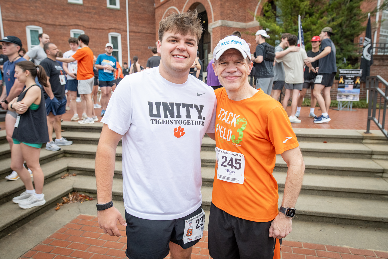 Hundreds of people participate in the 2026 Clemson 8 Challenge, an eight-mile run/walk/ruck march, on a misty Saturday morning, March 7, 2026. The Challenge was created to honor the 25 known Clemson alumni who suffered as POWs in all wars. It was originally created for 1938 Clemson alumnus, professor emeritus and WWII hero Ben Skardon, a survivor of the Bataan Death March, but has expanded to include Clemson POWs from all wars. Money raised from the event goes toward sending teams of Clemson ROTC students to participate in the Bataan Memorial Death March at White Sands Missile Range, NM. Sophomore finance major GB Stalnaker served as master of ceremonies. (Photo by Ken Scar)