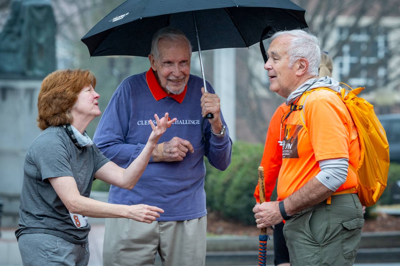 Hundreds of people participate in the 2026 Clemson 8 Challenge, an eight-mile run/walk/ruck march, on a misty Saturday morning, March 7, 2026. The Challenge was created to honor the 25 known Clemson alumni who suffered as POWs in all wars. It was originally created for 1938 Clemson alumnus, professor emeritus and WWII hero Ben Skardon, a survivor of the Bataan Death March, but has expanded to include Clemson POWs from all wars. Money raised from the event goes toward sending teams of Clemson ROTC students to participate in the Bataan Memorial Death March at White Sands Missile Range, NM. Sophomore finance major GB Stalnaker served as master of ceremonies. (Photo by Ken Scar)
