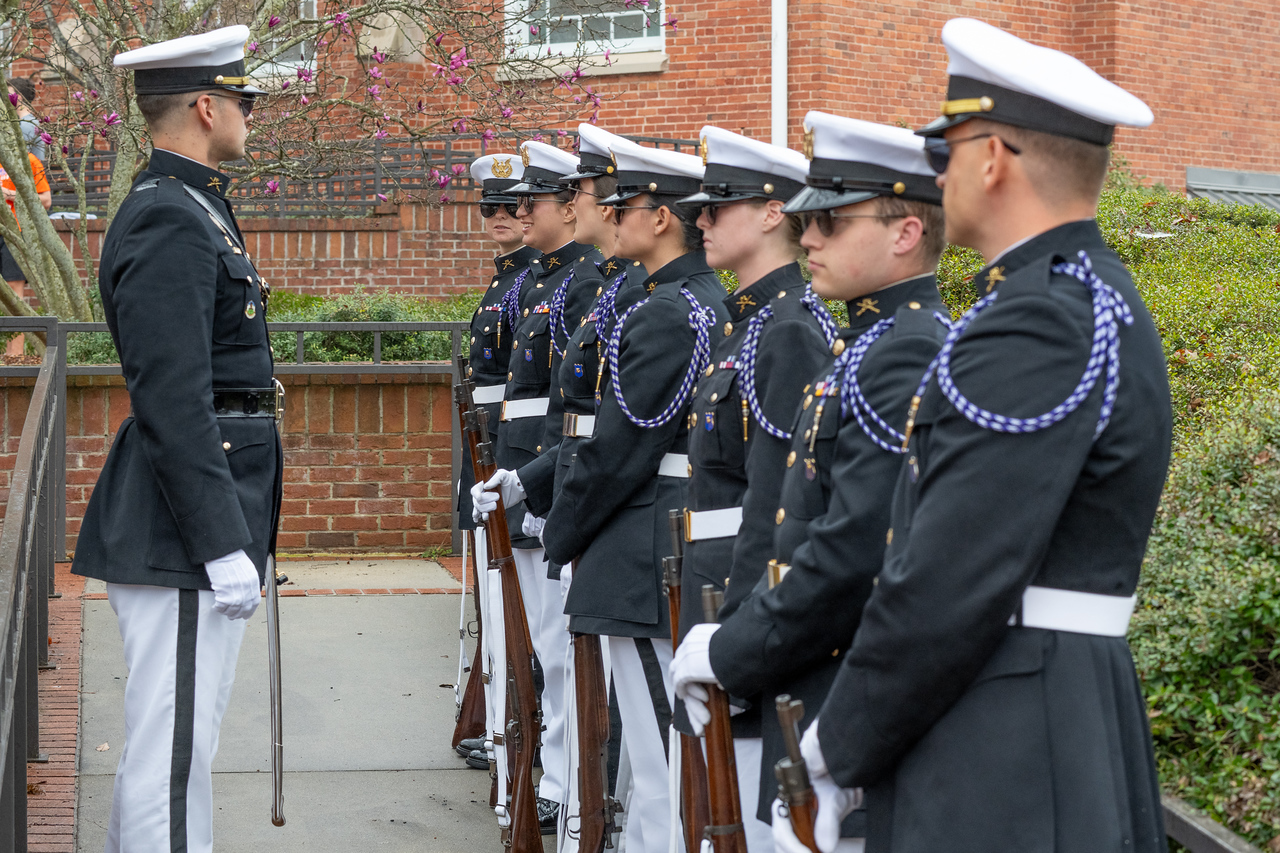 Hundreds of people participate in the 2026 Clemson 8 Challenge, an eight-mile run/walk/ruck march, on a misty Saturday morning, March 7, 2026. The Challenge was created to honor the 25 known Clemson alumni who suffered as POWs in all wars. It was originally created for 1938 Clemson alumnus, professor emeritus and WWII hero Ben Skardon, a survivor of the Bataan Death March, but has expanded to include Clemson POWs from all wars. Money raised from the event goes toward sending teams of Clemson ROTC students to participate in the Bataan Memorial Death March at White Sands Missile Range, NM. Sophomore finance major GB Stalnaker served as master of ceremonies. (Photo by Ken Scar)