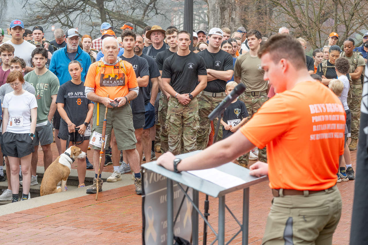 Hundreds of people participate in the 2026 Clemson 8 Challenge, an eight-mile run/walk/ruck march, on a misty Saturday morning, March 7, 2026. The Challenge was created to honor the 25 known Clemson alumni who suffered as POWs in all wars. It was originally created for 1938 Clemson alumnus, professor emeritus and WWII hero Ben Skardon, a survivor of the Bataan Death March, but has expanded to include Clemson POWs from all wars. Money raised from the event goes toward sending teams of Clemson ROTC students to participate in the Bataan Memorial Death March at White Sands Missile Range, NM. Sophomore finance major GB Stalnaker served as master of ceremonies. (Photo by Ken Scar)
