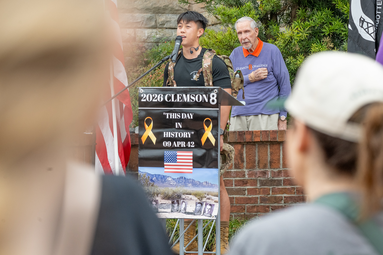 Hundreds of people participate in the 2026 Clemson 8 Challenge, an eight-mile run/walk/ruck march, on a misty Saturday morning, March 7, 2026. The Challenge was created to honor the 25 known Clemson alumni who suffered as POWs in all wars. It was originally created for 1938 Clemson alumnus, professor emeritus and WWII hero Ben Skardon, a survivor of the Bataan Death March, but has expanded to include Clemson POWs from all wars. Money raised from the event goes toward sending teams of Clemson ROTC students to participate in the Bataan Memorial Death March at White Sands Missile Range, NM. Sophomore finance major GB Stalnaker served as master of ceremonies. (Photo by Ken Scar)