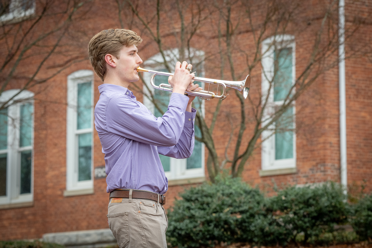 Hundreds of people participate in the 2026 Clemson 8 Challenge, an eight-mile run/walk/ruck march, on a misty Saturday morning, March 7, 2026. The Challenge was created to honor the 25 known Clemson alumni who suffered as POWs in all wars. It was originally created for 1938 Clemson alumnus, professor emeritus and WWII hero Ben Skardon, a survivor of the Bataan Death March, but has expanded to include Clemson POWs from all wars. Money raised from the event goes toward sending teams of Clemson ROTC students to participate in the Bataan Memorial Death March at White Sands Missile Range, NM. Sophomore finance major GB Stalnaker served as master of ceremonies. (Photo by Ken Scar)