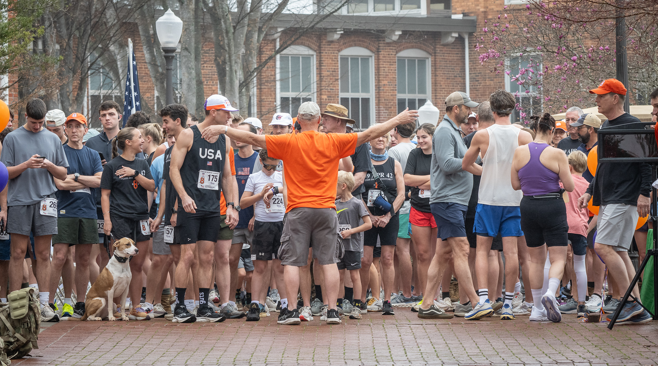 Hundreds of people participate in the 2026 Clemson 8 Challenge, an eight-mile run/walk/ruck march, on a misty Saturday morning, March 7, 2026. The Challenge was created to honor the 25 known Clemson alumni who suffered as POWs in all wars. It was originally created for 1938 Clemson alumnus, professor emeritus and WWII hero Ben Skardon, a survivor of the Bataan Death March, but has expanded to include Clemson POWs from all wars. Money raised from the event goes toward sending teams of Clemson ROTC students to participate in the Bataan Memorial Death March at White Sands Missile Range, NM. Sophomore finance major GB Stalnaker served as master of ceremonies. (Photo by Ken Scar)