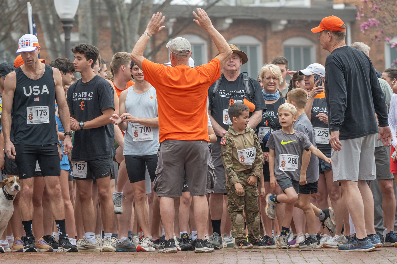 Hundreds of people participate in the 2026 Clemson 8 Challenge, an eight-mile run/walk/ruck march, on a misty Saturday morning, March 7, 2026. The Challenge was created to honor the 25 known Clemson alumni who suffered as POWs in all wars. It was originally created for 1938 Clemson alumnus, professor emeritus and WWII hero Ben Skardon, a survivor of the Bataan Death March, but has expanded to include Clemson POWs from all wars. Money raised from the event goes toward sending teams of Clemson ROTC students to participate in the Bataan Memorial Death March at White Sands Missile Range, NM. Sophomore finance major GB Stalnaker served as master of ceremonies. (Photo by Ken Scar)