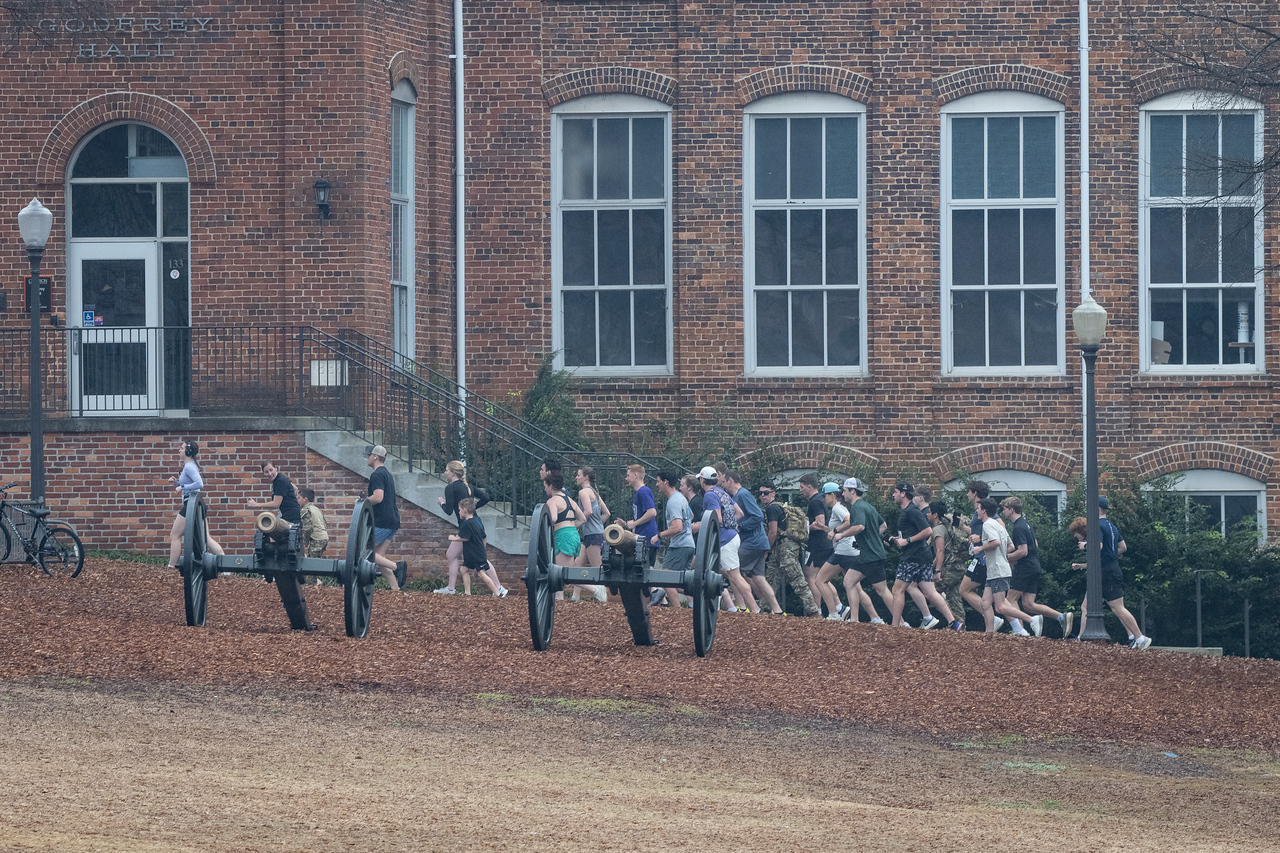 Hundreds of people participate in the 2026 Clemson 8 Challenge, an eight-mile run/walk/ruck march, on a misty Saturday morning, March 7, 2026. The Challenge was created to honor the 25 known Clemson alumni who suffered as POWs in all wars. It was originally created for 1938 Clemson alumnus, professor emeritus and WWII hero Ben Skardon, a survivor of the Bataan Death March, but has expanded to include Clemson POWs from all wars. Money raised from the event goes toward sending teams of Clemson ROTC students to participate in the Bataan Memorial Death March at White Sands Missile Range, NM. Sophomore finance major GB Stalnaker served as master of ceremonies. (Photo by Ken Scar)