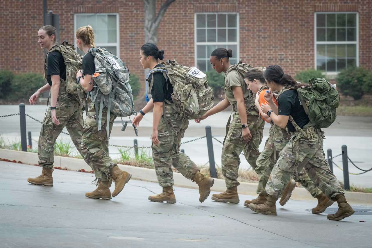 Hundreds of people participate in the 2026 Clemson 8 Challenge, an eight-mile run/walk/ruck march, on a misty Saturday morning, March 7, 2026. The Challenge was created to honor the 25 known Clemson alumni who suffered as POWs in all wars. It was originally created for 1938 Clemson alumnus, professor emeritus and WWII hero Ben Skardon, a survivor of the Bataan Death March, but has expanded to include Clemson POWs from all wars. Money raised from the event goes toward sending teams of Clemson ROTC students to participate in the Bataan Memorial Death March at White Sands Missile Range, NM. Sophomore finance major GB Stalnaker served as master of ceremonies. (Photo by Ken Scar)