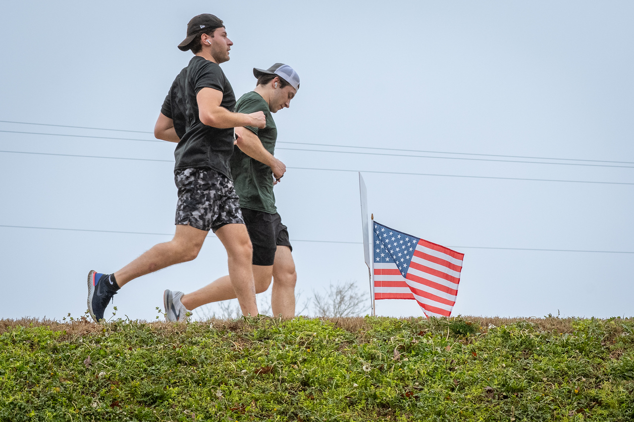Hundreds of people participate in the 2026 Clemson 8 Challenge, an eight-mile run/walk/ruck march, on a misty Saturday morning, March 7, 2026. The Challenge was created to honor the 25 known Clemson alumni who suffered as POWs in all wars. It was originally created for 1938 Clemson alumnus, professor emeritus and WWII hero Ben Skardon, a survivor of the Bataan Death March, but has expanded to include Clemson POWs from all wars. Money raised from the event goes toward sending teams of Clemson ROTC students to participate in the Bataan Memorial Death March at White Sands Missile Range, NM. Sophomore finance major GB Stalnaker served as master of ceremonies. (Photo by Ken Scar)