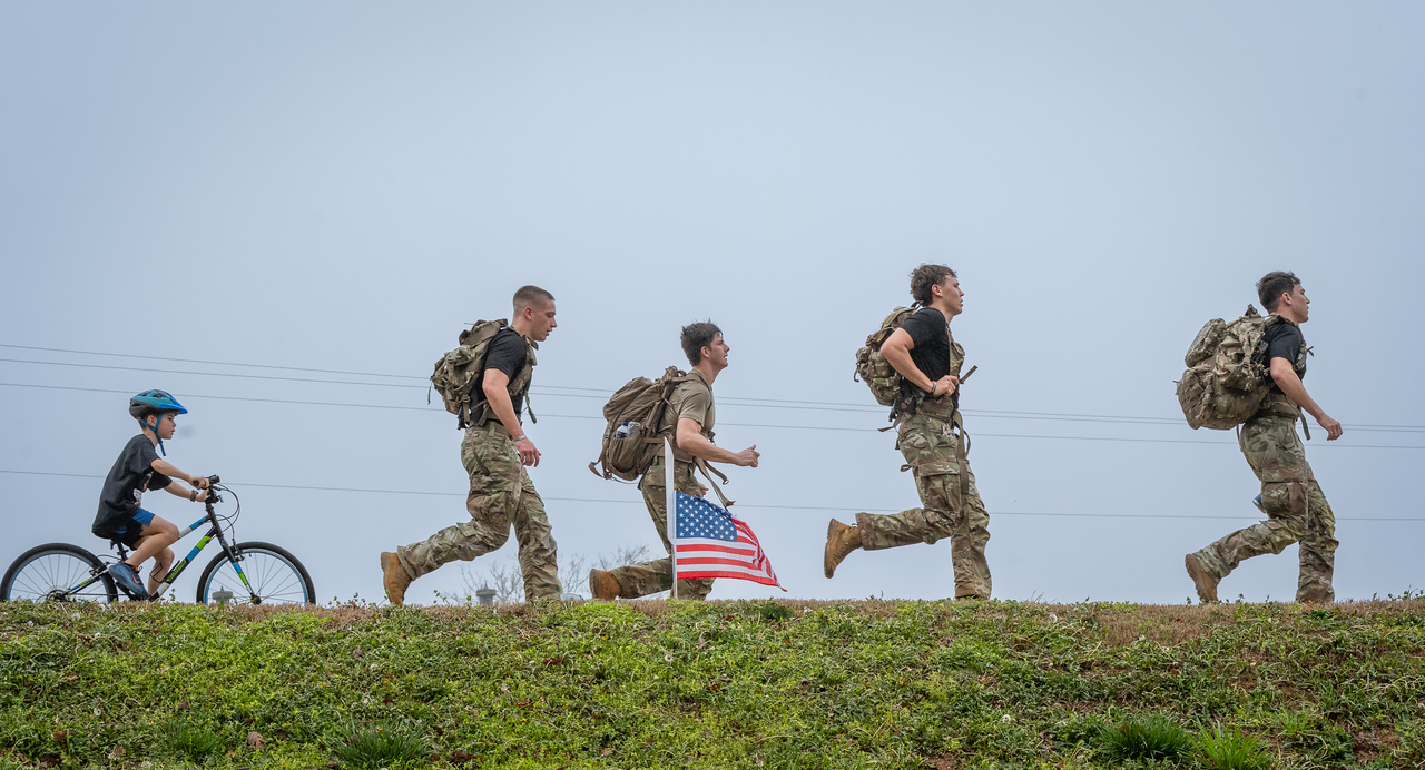 Hundreds of people participate in the 2026 Clemson 8 Challenge, an eight-mile run/walk/ruck march, on a misty Saturday morning, March 7, 2026. The Challenge was created to honor the 25 known Clemson alumni who suffered as POWs in all wars. It was originally created for 1938 Clemson alumnus, professor emeritus and WWII hero Ben Skardon, a survivor of the Bataan Death March, but has expanded to include Clemson POWs from all wars. Money raised from the event goes toward sending teams of Clemson ROTC students to participate in the Bataan Memorial Death March at White Sands Missile Range, NM. Sophomore finance major GB Stalnaker served as master of ceremonies. (Photo by Ken Scar)