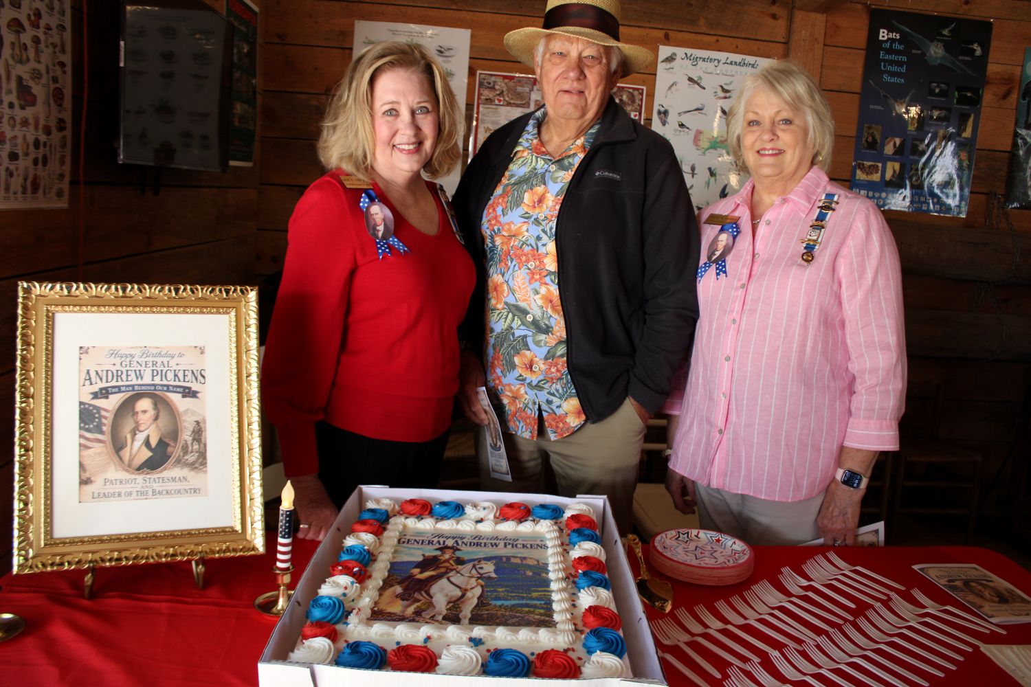Siblings Julie Mays Thompson, Harry Mays, Jr., and Dianne Mays Crooks, descendants of General Andrew Pickens, pose with the birthday cake depicting their ancestor on horseback. (Photo by Karen Brewer, The Pickens County Chronicle)