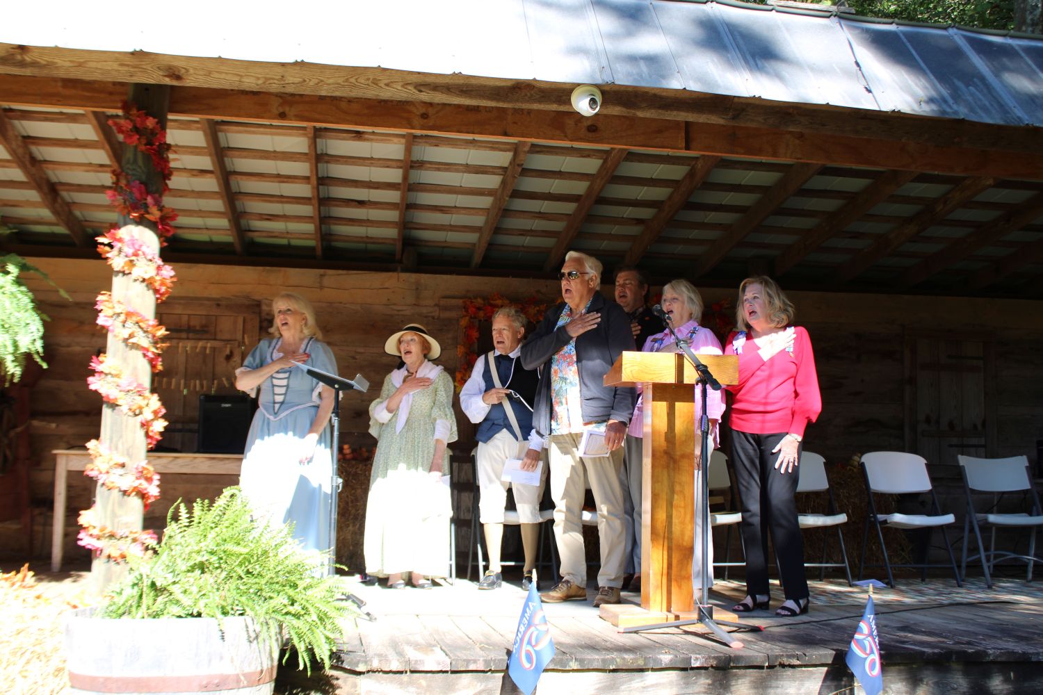 Pickens County America 250 Chair Carolyn Nations, Fort Prince George DAR Chapter Regent Joyce Hansel, General Andrew Pickens SAR Chapter President Bud Starnes, Andrew Pickens descendants Harry Mays, Jr., Dianne Mays Crooks, and Julie Mays Thompson, and keynote speaker Dr. Otis Pickett are pictured during the Pledge of Allegiance. (Photo by Karen Brewer, The Pickens County Chronicle)