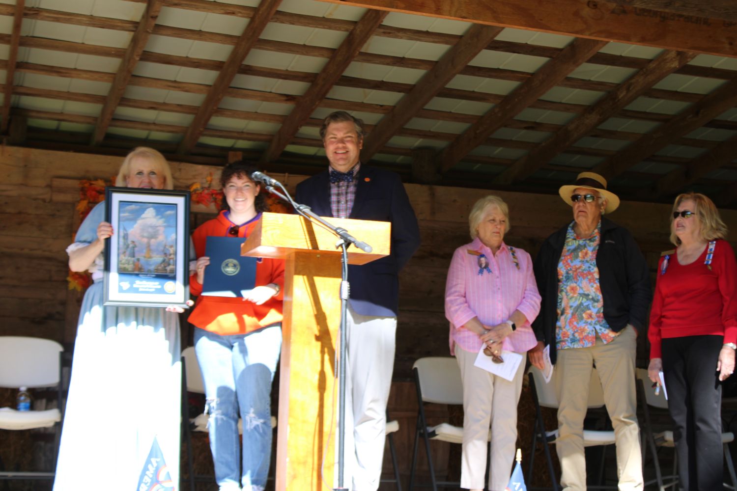 Hannah Thompson from Clemson University Historic Properties presents a print from the South Carolina 250 Commission and a Proclamation from the Governor. (Photo by Karen Brewer, The Pickens County Chronicle)