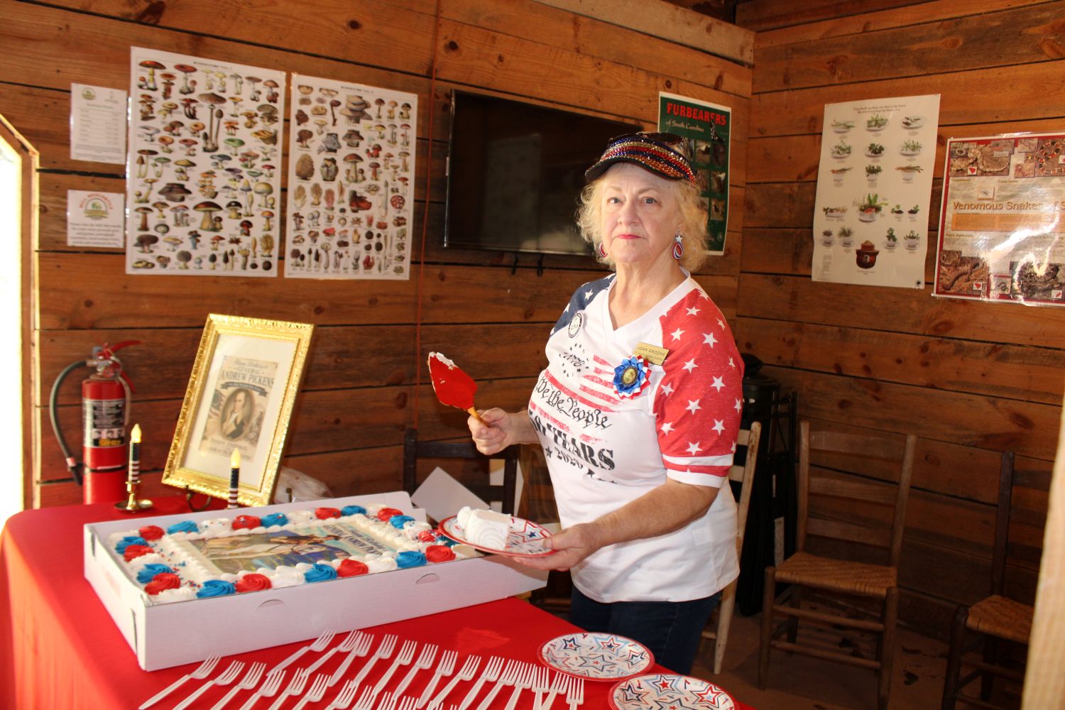 Pickens County America 250 Committee member Joan Groome cuts the birthday cake. (Photo by Karen Brewer, The Pickens County Chronicle)