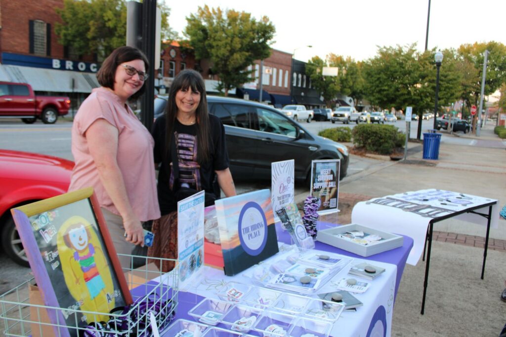 Angela Johnson, a board member for The Hiding Place, and Tricia Griffin man a table with information on The Hiding Place prior to the start of the candlelight vigil on October 1, 2026. (Photo by Karen Brewer, The Pickens County Chronicle)
