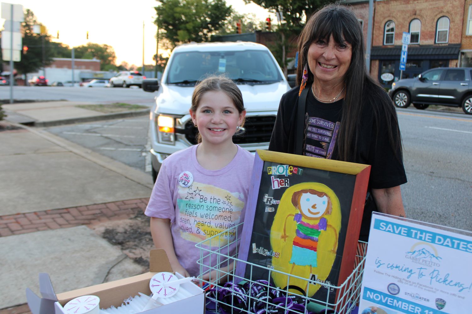 Emberly Nicholson (who designed the artwork pictured) and her aunt, Tricia Griffin, prior to the start of the candlelight vigil ceremony on Thursday, October 1, 2026. (Photo by Karen Brewer, The Pickens County Chronicle)